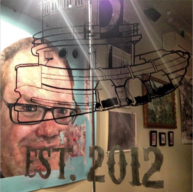 PLG Arts Repre Show through Window